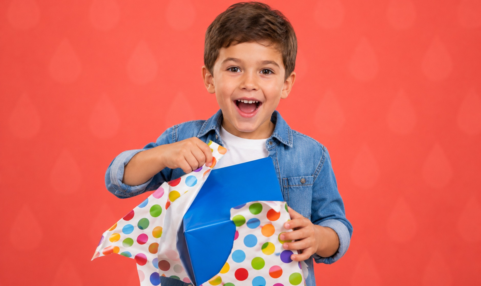 A boy tearing open a wrapped gift, surprised and delighted